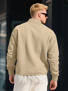 Close-up back view of men's beige polo shirt featuring a unique diamond knit texture