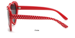 Side view of red heart-shaped sunglasses with white polka dots and dark lenses