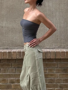 Grey elastic tube top paired with sage green cargo skirt for a minimalist sporty look