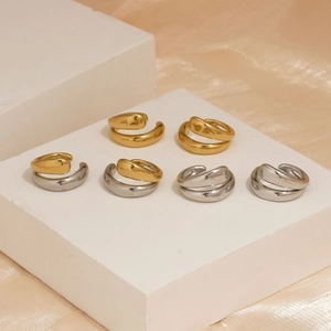 Sleek 316 stainless steel hoop earrings in gold and silver finish on silk background