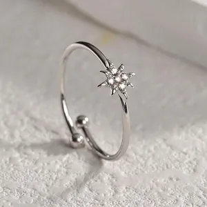 Macro shot of silver titanium octagonal star ring with pave-set clear gemstones