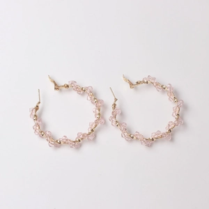 Elegant gold-wire hoop earrings with pink crystal beads and a minimalist design