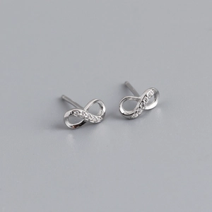 Macro shot of silver infinity stud earrings with sparkling cubic zirconia pavé details