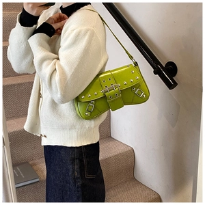 Sac baguette Y2K vert citron avec clous argentés et boucles porté à l'épaule