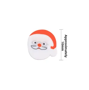 Macro detail of 10mm Santa Claus polymer clay beads for DIY Christmas jewelry making