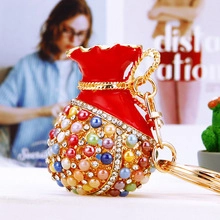 Detail of red fortune bag keychain with colorful pearls and sparkling rhinestones