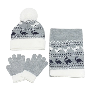 Close-up of grey and white dinosaur pattern knit hat, scarf and gloves set for boys