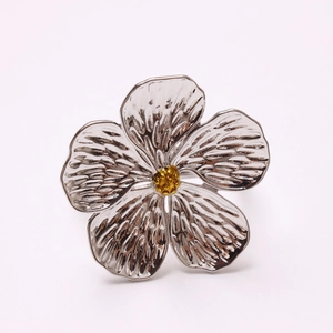 Silver plum blossom napkin ring with golden stamen and textured metal petals