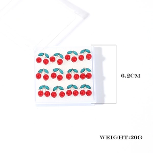 Macro view of 12 pairs of cherry stud earrings in white display box with weight info