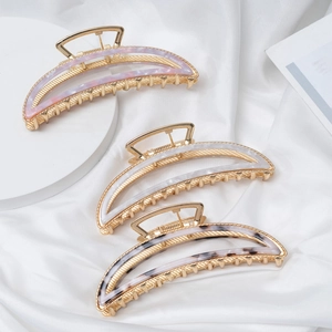 Three elegant acetate half-moon hair claws in pink, white, and black marble patterns