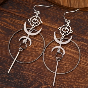 Silver long drop earrings with Evil Eye and crescent moon on brown wood background