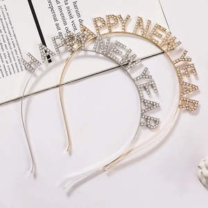 Close-up of gold and silver HAPPY NEW YEAR headbands featuring sparkly rhinestones