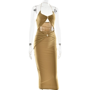 Detail of the golden knitted halter neck midi dress with elegant cut-out waist design