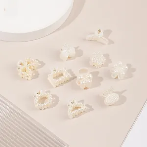 Detailed flat lay of mini faux pearl hair clips in butterfly and flower shapes