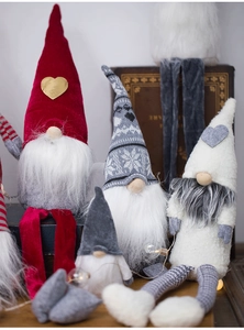 Cozy Christmas gnomes with knit hats and faux fur beards on a warm wooden background