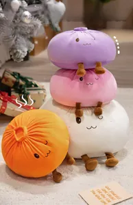 Close-up of soft plush bun pillows in purple and pink with cute embroidered faces