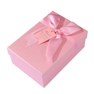 Pink rectangular cardboard gift box with elegant satin ribbon bow and beloved gift tag