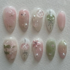 Pink and green press-on nails with 3D embossed flowers, pearls and lotus motifs