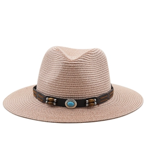 Detailed macro view of woven straw hat featuring turquoise beads and silver metal carving