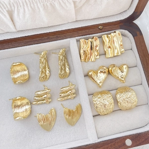 Assorted 14k gold plated irregular heart and square stud earrings in a wooden jewelry box