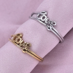 304 stainless steel gold and silver rings with love letter design on pink fabric