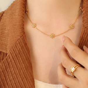 Elegant gold daisy necklace with 3D floral pendants and zirconia ring on model
