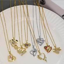Close-up of assorted heart pendants with pink and red zircon stones on a white tray