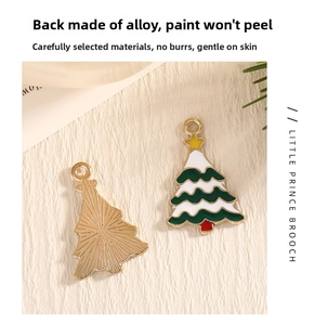 Detailed view of alloy Christmas tree pendant with green enamel and gold star