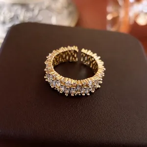 Minimalist gold open ring with rectangle and round cubic zirconia on leather