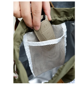 Detail of the mesh interior pocket of the green lunch bag for organizing small items