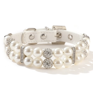 Close-up of double-row pearl pet collar with sparkling rhinestone balls and PU leather