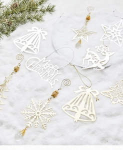 Close-up of golden and silver镂空 Christmas ornaments with reindeer and snowflake details
