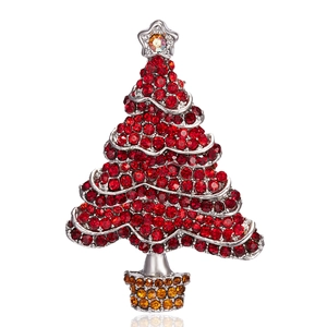 Sparkling Christmas tree brooch with red rhinestones and silver alloy plating on white background