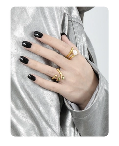 Detailed view of irregular baroque pearl ring and abstract open design in gold finish