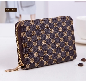 Detailed macro view of a coffee brown mini wallet featuring classic clover monogram pattern