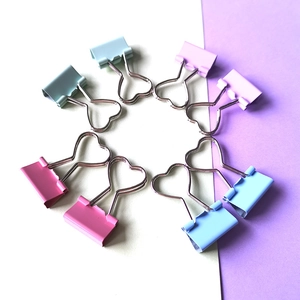 Macro view of heart-shaped hollow metal binder clips in assorted macaron colors