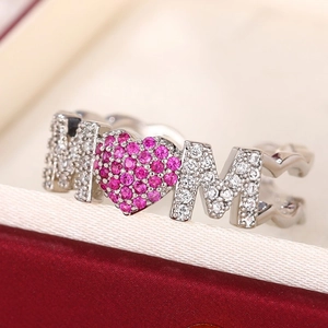Macro detail of MOM ring featuring pink zircon heart and micro-pave white stones