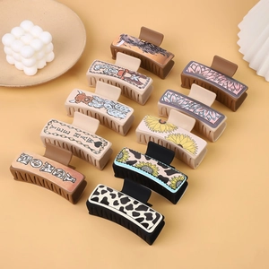 Western style faux leather hair claws with cactus and sunflower patterns in neutral tones