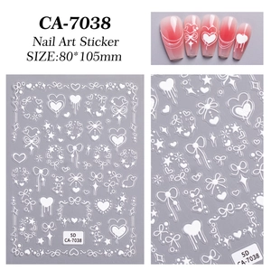 Detailed view of 5D white embossed nail stickers with heart and bow designs