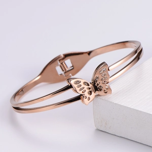 Elegant rose gold butterfly bracelet with zircon details on white geometric stone