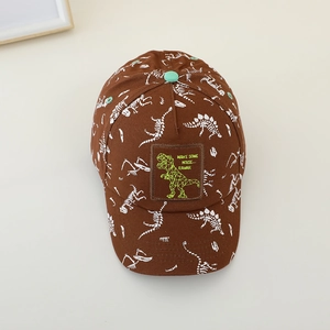 Detail view of dinosaur skeleton print on brown canvas kids baseball cap with patch