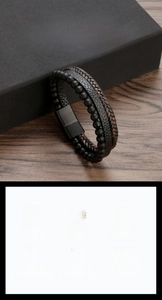 Macro shot of men's leather braided bracelet with beads and magnetic stainless steel clasp