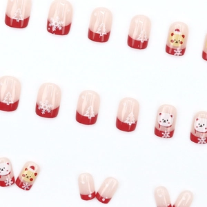 Christmas press-on nails with red and nude festive patterns of bears and snowflakes