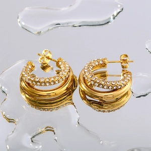 18K gold plated stainless steel double-hoop earrings with crystals on a reflective surface