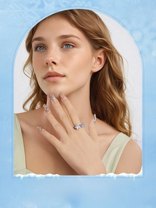 Detailed close-up of a model wearing a double blue butterfly ring in silver