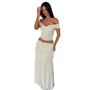 Detail of polka dot crop top with V-neck knot and matching tiered high waist maxi skirt
