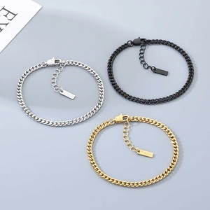 Detailed view of silver, gold and black Cuban link bracelets made of durable stainless steel