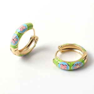 Detail of gold circular earrings with green enamel inlay and blue floral patterns