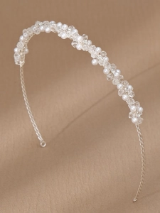 Detail of handmade bridal headband with white pearls and transparent crystal beads