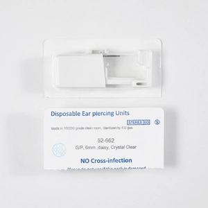Macro detail of sterile disposable ear piercing unit with surgical steel stud packaging
